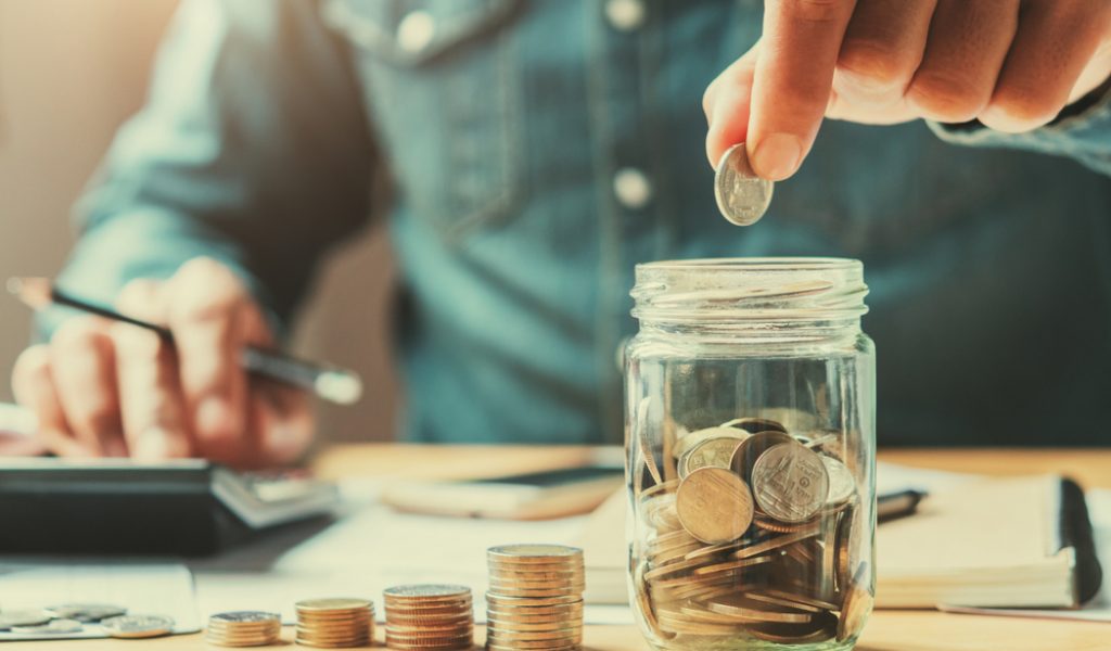 Businessman,Holding,Coins,Putting,In,Glass.,Concept,Saving,Money,For